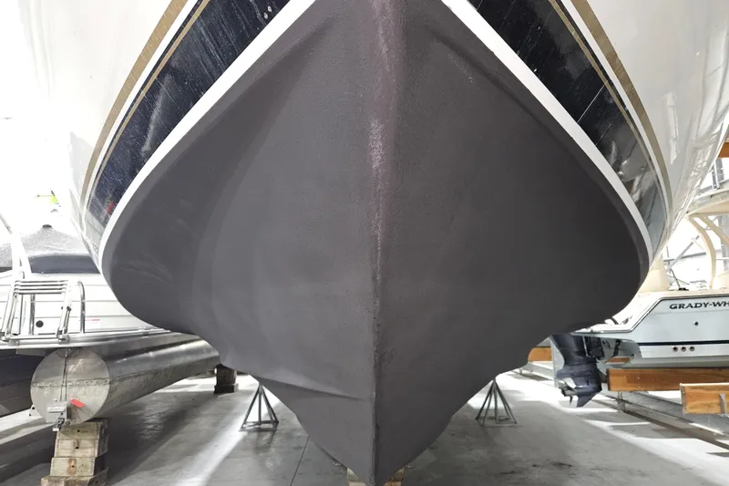 Slide: The Image of 1999 Carver 450 Voyager Pilothouse boat hull in dry dock, showcasing sleek design. - 54