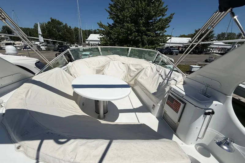 Slide: The Image of 1999 Carver 450 Voyager Pilothouse yacht with spacious outdoor seating and table. - 8