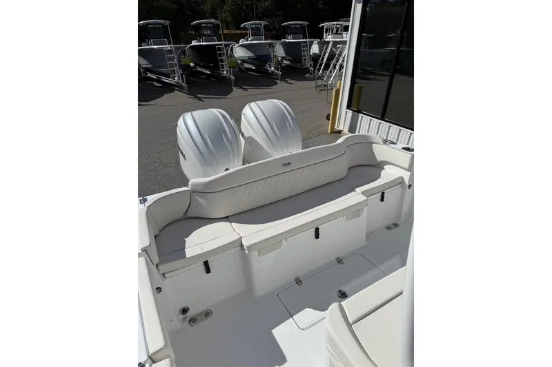 Slide: The Image of 2026 Sea Hunt Ultra 285 Coffin Box boat interior with white seating and cup holders. - 15
