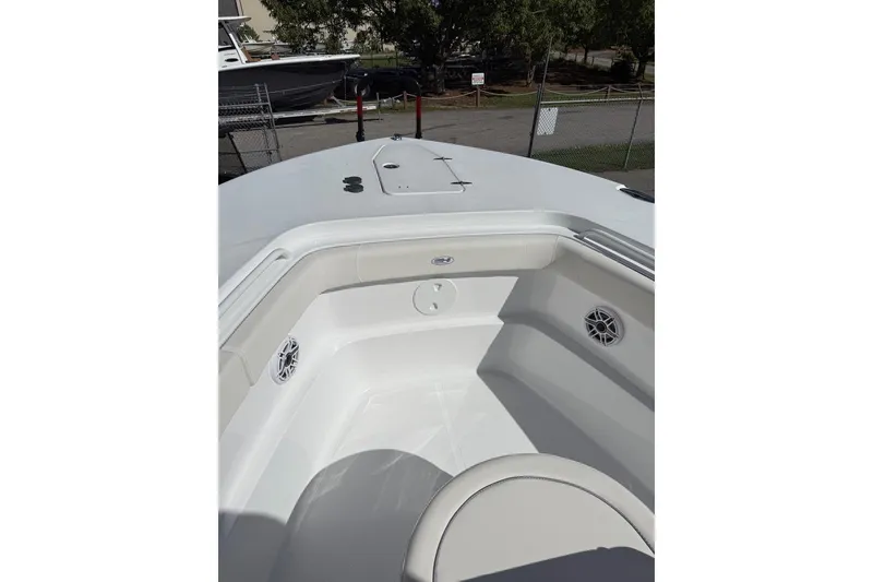 Slide: The Image of 2026 Sea Hunt Ultra 285 Coffin Box boat on trailer under clear blue sky. - 3