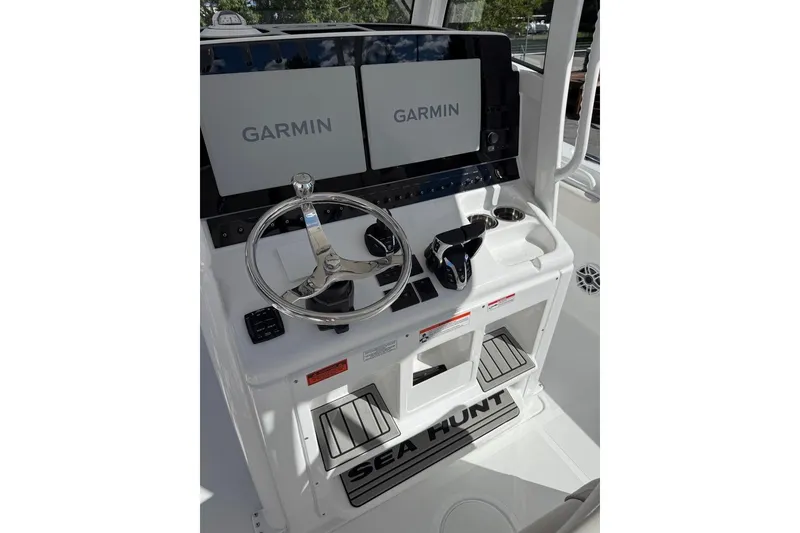 Slide: The Image of 2026 Sea Hunt Ultra 285 Coffin Box boat seating area with steering wheel. - 8