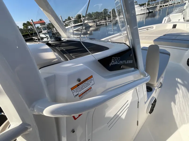 Slide: The Image of The image shows the cockpit of a 2027 Boston Whaler 220 Dauntless, featuring sleek lines and modern details. - 14