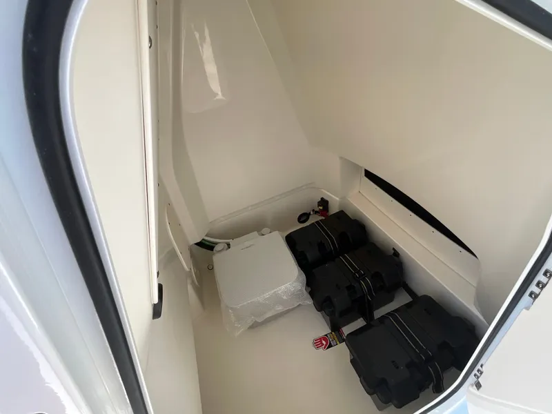 Slide: The Image of Interior view of a 2027 Boston Whaler 220 Dauntless with batteries and storage space. - 15