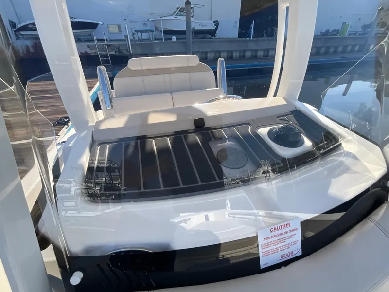 Slide: The Image of The image shows the cockpit of a 2027 Boston Whaler 220 Dauntless with modern seating and controls. - 21