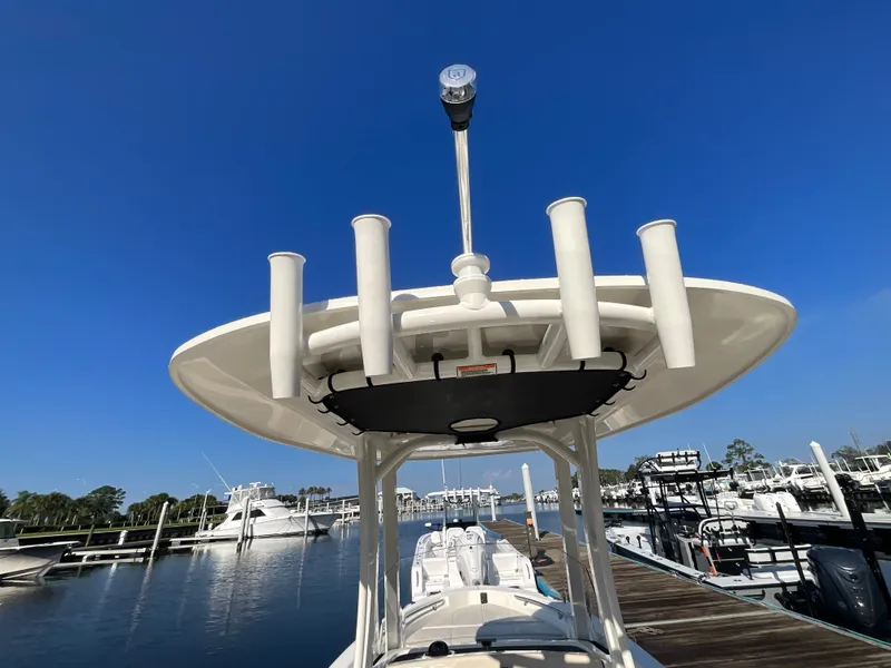 Slide: The Image of A 2027 Boston Whaler 220 Dauntless is docked. The sky is clear and blue. - 25