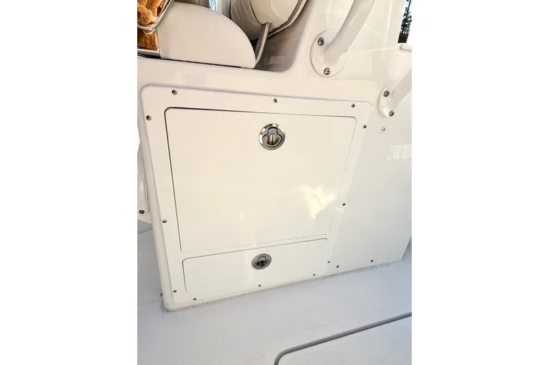Slide: The Image of 2026 Sea Hunt Ultra 275 Coffin Box interior storage compartment open. - 16