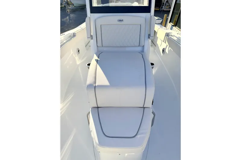Slide: The Image of Storage compartment with two sealed containers on a 2026 Sea Hunt Ultra 275 Coffin Box boat. - 19