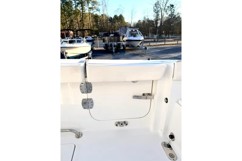 Slide: The Image of 2026 Sea Hunt Ultra 275 Coffin Box boat with open storage compartments and dual engines. - 22