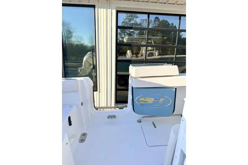 Slide: The Image of 2026 Sea Hunt Ultra 275 Coffin Box interior with white seating and storage compartment. - 23
