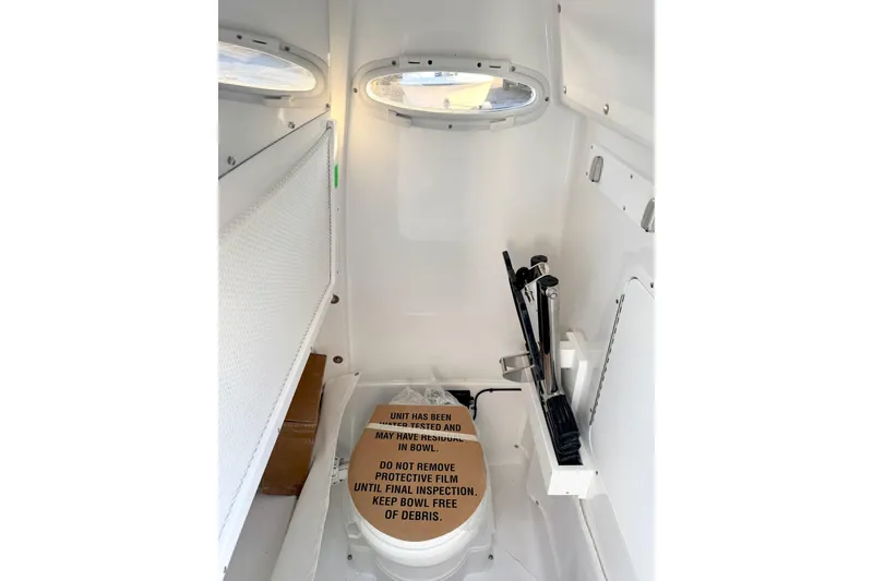 Slide: The Image of Interior of 2026 Sea Hunt Ultra 275 Coffin Box boat with toilet and storage. - 25