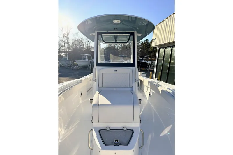 Slide: The Image of 2026 Sea Hunt Ultra 275 Coffin Box boat at a marina under clear blue sky. - 9