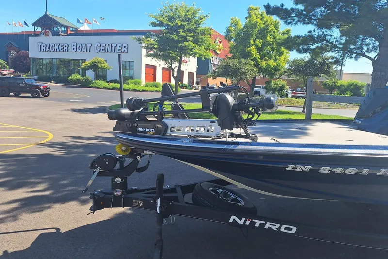 Slide: The Image of 2019 Nitro Z20 boat parked outside Tracker Boat Center on a sunny day. - 2
