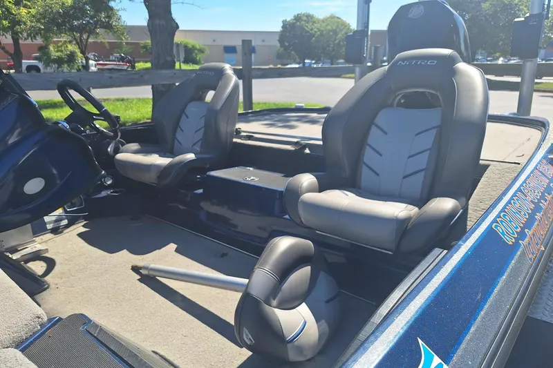 Slide: The Image of 2019 Nitro Z20 boat interior with two gray seats and steering wheel. - 6