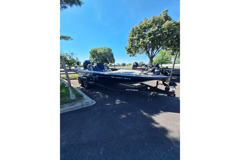 Slide: The Image of 2019 Nitro Z20 boat parked on a sunny day, surrounded by trees. - 8