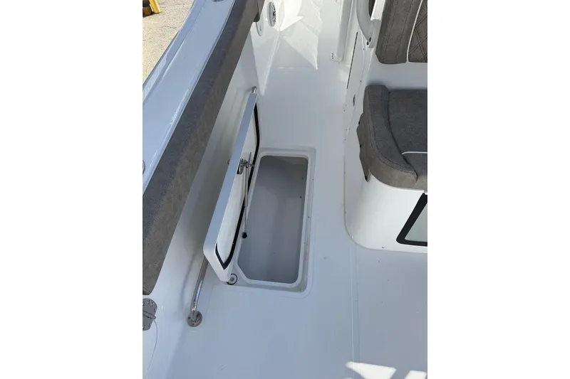 Slide: The Image of 2026 Sea Hunt Ultra 275 Coffin Box interior with open storage compartment. - 11