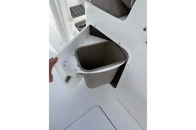 Slide: The Image of Storage compartment with trash bin on 2026 Sea Hunt Ultra 275 Coffin Box boat. - 12