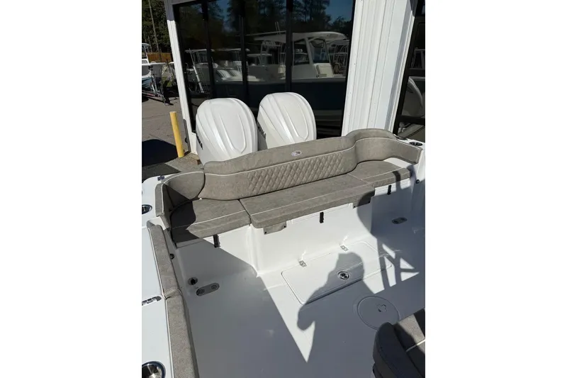 Slide: The Image of 2026 Sea Hunt Ultra 275 Coffin Box boat interior with cushioned seating and dual engines. - 14