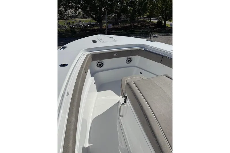 Slide: The Image of 2026 Sea Hunt Ultra 275 Coffin Box boat interior with cushioned seating and speakers. - 18