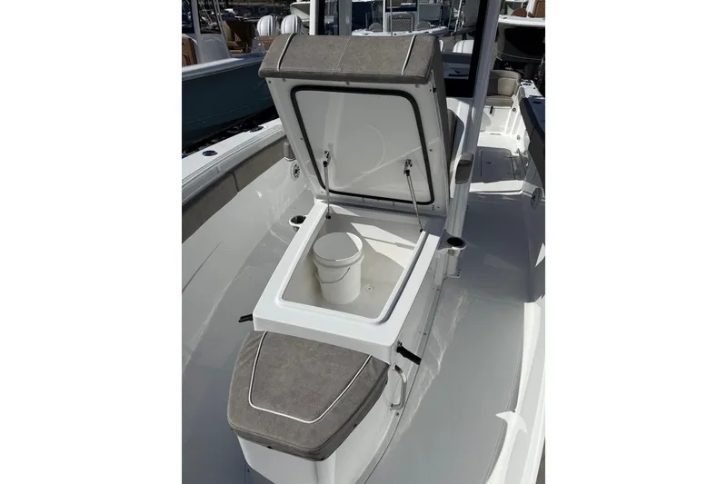 Slide: The Image of 2026 Sea Hunt Ultra 275 Coffin Box with open storage compartment on deck. - 20