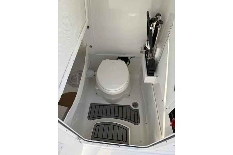 Slide: The Image of Interior of 2026 Sea Hunt Ultra 275 Coffin Box boat bathroom with toilet and storage. - 21