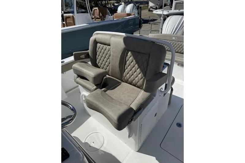 Slide: The Image of 2026 Sea Hunt Ultra 275 Coffin Box boat seating with cushioned armrests and diamond-pattern upholstery. - 22