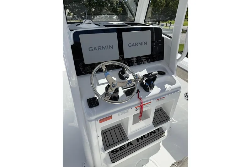 Slide: The Image of 2026 Sea Hunt Ultra 275 Coffin Box helm with dual Garmin displays and steering wheel. - 23