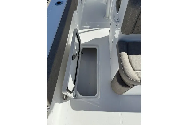 Slide: The Image of 2026 Sea Hunt Ultra 275 Coffin Box interior with open storage compartment. - 27