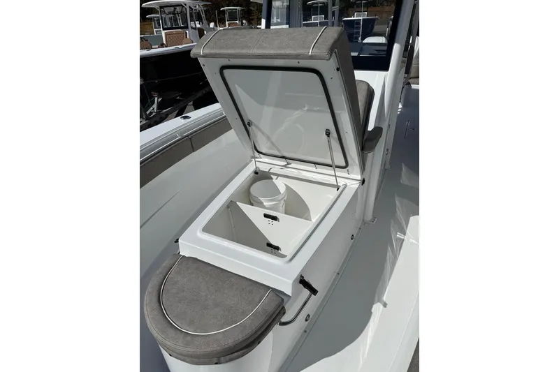 Slide: The Image of 2026 Sea Hunt Ultra 275 Coffin Box with open storage compartment on deck. - 5