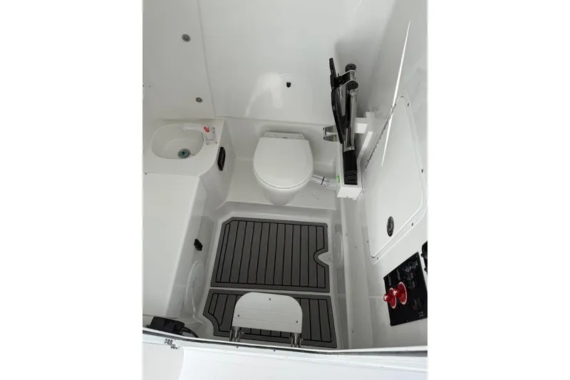 Slide: The Image of Interior of 2026 Sea Hunt Ultra 275 Coffin Box boat, featuring a compact bathroom setup. - 6