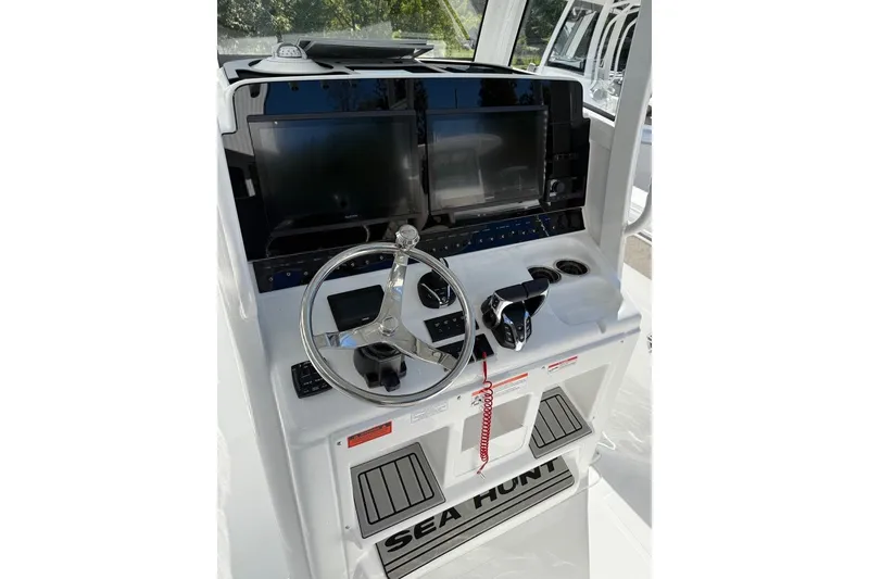 Slide: The Image of 2026 Sea Hunt Ultra 275 Coffin Box helm with dual screens and steering wheel. - 8