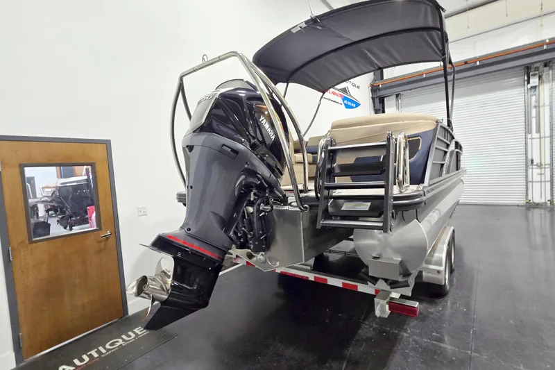 Slide: The Image of 2026 Bennington 23 L pontoon boat with Yamaha outboard motor in showroom. - 4