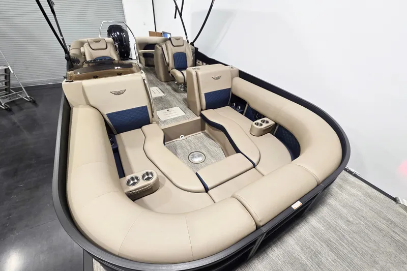 Slide: The Image of 2026 Bennington 23 L pontoon boat interior with beige seating and blue accents. - 7