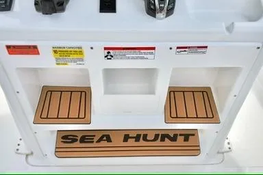 Slide: The Image of 2026 Sea Hunt Ultra 255 SE boat console with storage compartments and Sea Hunt branding. - 12