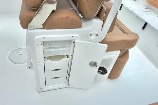 Slide: The Image of 2026 Sea Hunt Ultra 255 SE boat seating with storage compartments open. - 16