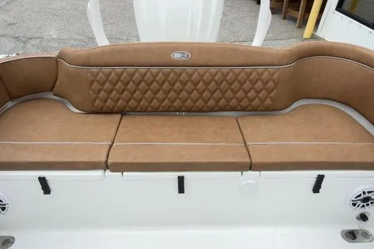 Slide: The Image of Luxurious tan seating on 2026 Sea Hunt Ultra 255 SE boat, featuring diamond-patterned upholstery. - 18