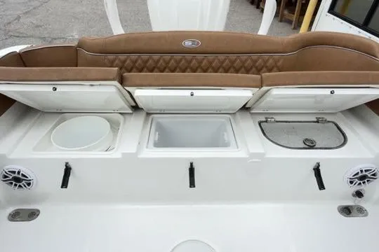 Slide: The Image of 2026 Sea Hunt Ultra 255 SE boat interior with storage compartments and seating. - 19