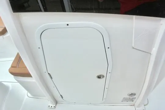 Slide: The Image of 2026 Sea Hunt Ultra 255 SE boat hatch door, white with secure latch. - 21