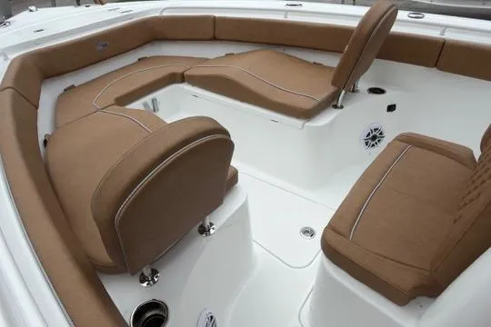 Slide: The Image of Luxurious seating on 2026 Sea Hunt Ultra 255 SE boat, featuring brown cushions and white deck. - 22
