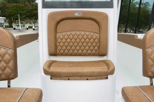 Slide: The Image of 2026 Sea Hunt Ultra 255 SE boat interior with tan diamond-stitched seating. - 23