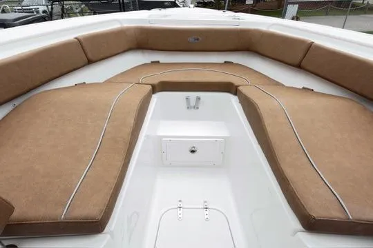 Slide: The Image of 2026 Sea Hunt Ultra 255 SE boat interior with tan cushioned seating. - 24