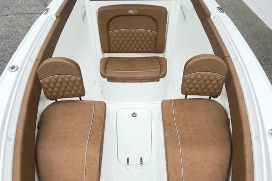Slide: The Image of 2026 Sea Hunt Ultra 255 SE boat interior with tan cushioned seating. - 25