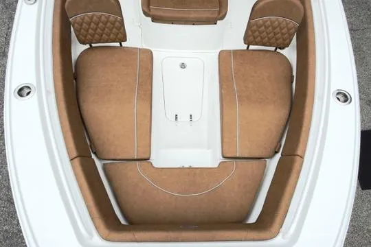 Slide: The Image of 2026 Sea Hunt Ultra 255 SE boat interior with brown cushioned seating. - 26