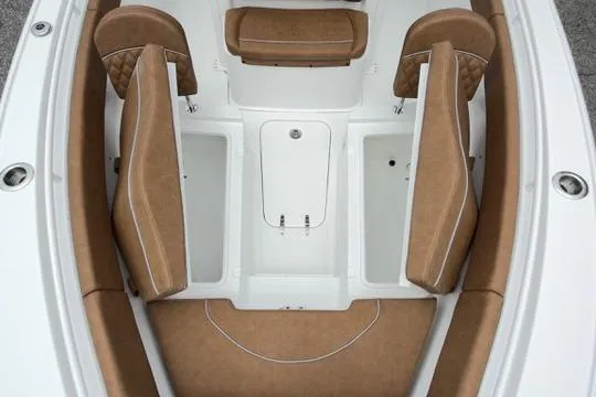Slide: The Image of 2026 Sea Hunt Ultra 255 SE boat interior with tan seating and storage compartments. - 27