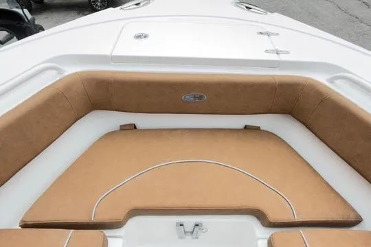 Slide: The Image of 2026 Sea Hunt Ultra 255 SE boat interior with tan cushioned seating. - 29