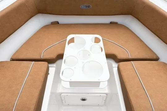 Slide: The Image of 2026 Sea Hunt Ultra 255 SE boat interior with cushioned seating and cup holders. - 30