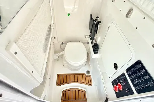 Slide: The Image of 2026 Sea Hunt Ultra 255 SE boat interior with toilet and control panel. - 32