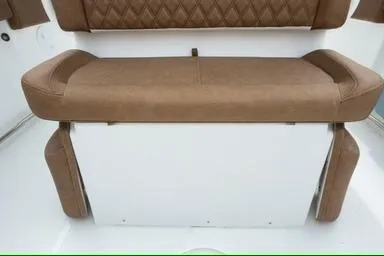 Slide: The Image of 2026 Sea Hunt Ultra 255 SE boat seat with brown upholstery and white base. - 8