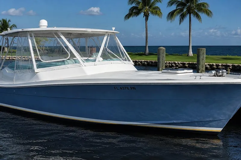 The Image of 1990 Topaz 39 Royale boat docked by palm trees and ocean. - 0