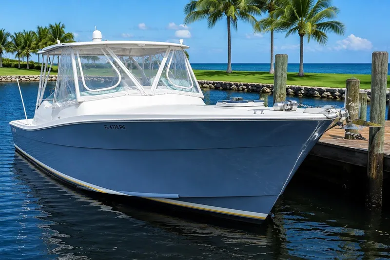 Slide: The Image of 1990 Topaz 39 Royale boat docked by palm trees and ocean. - 1