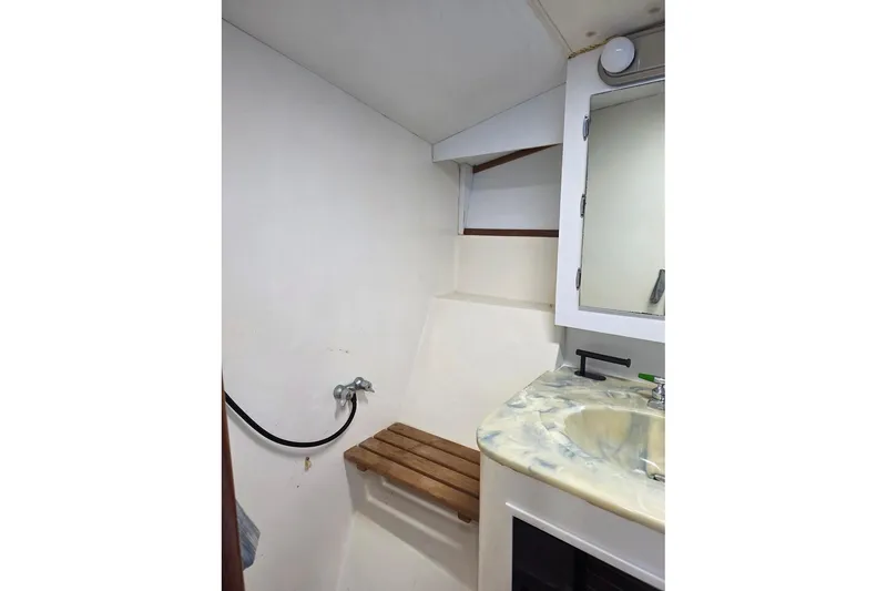 Slide: The Image of 1990 Topaz 39 Royale bathroom with marble sink, wooden seat, and mirror cabinet. - 15